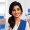 RJ Packers and Movers friendly Indian female customer portrait, natural smile, neutral premium background with subtle blue-and-white logistics accent